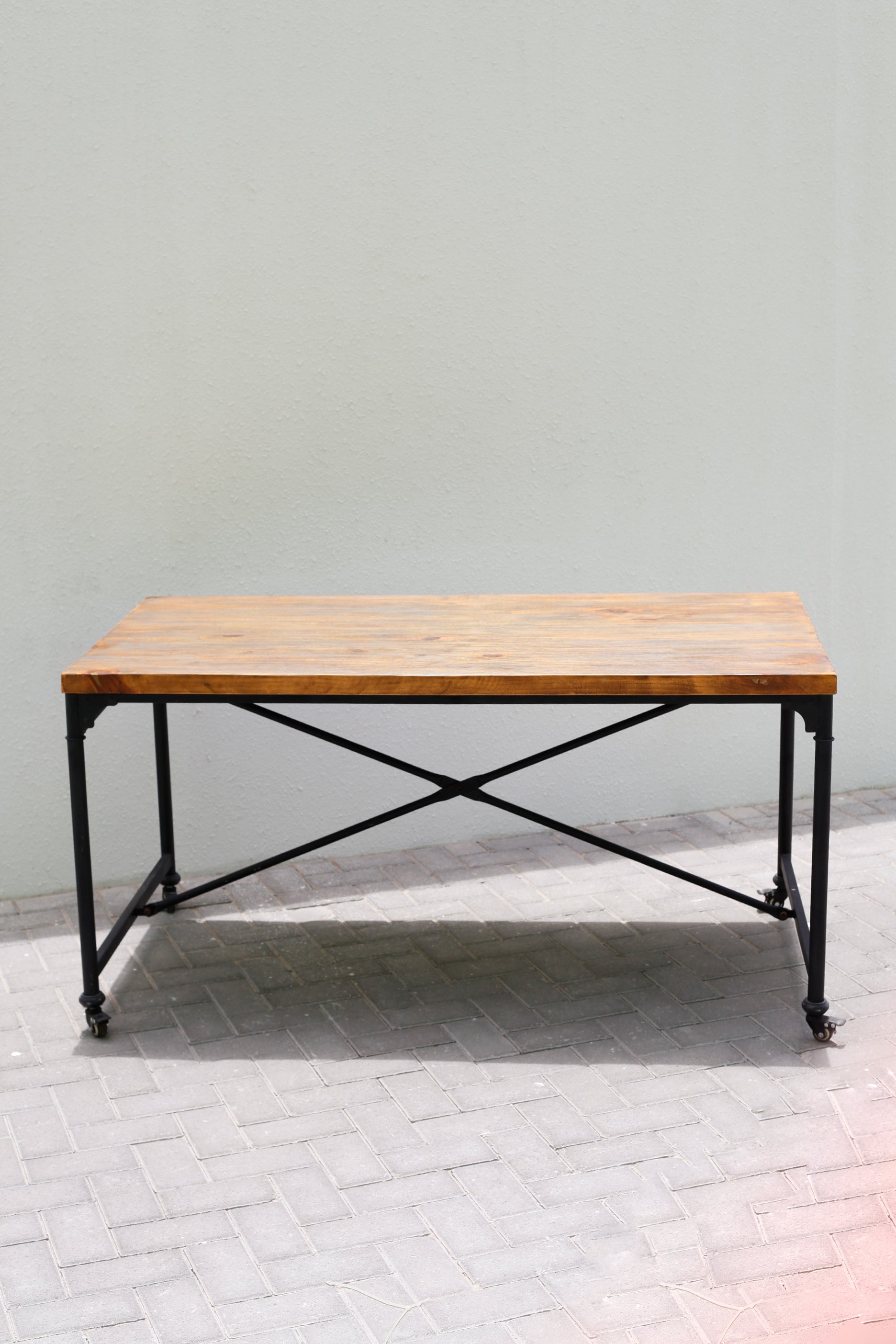 WOODEN TABLE ON WHEELS WITH BLACK STEEL LEGS