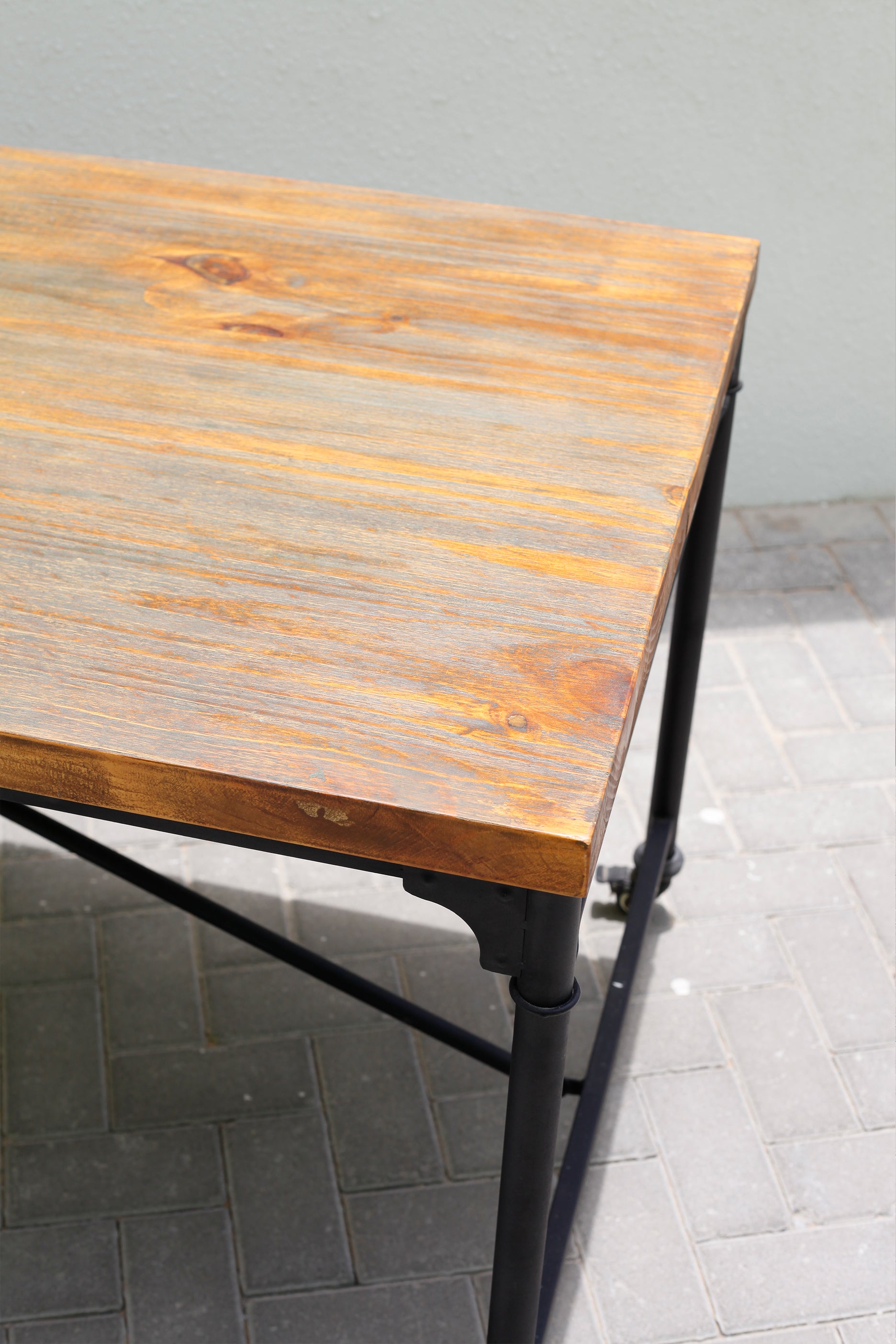 WOODEN TABLE ON WHEELS WITH BLACK STEEL LEGS